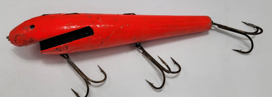 LARGE ORANGE WOODEN 10" LURE with BLACK EYES AND MOUTH AND 3 HOOKS.