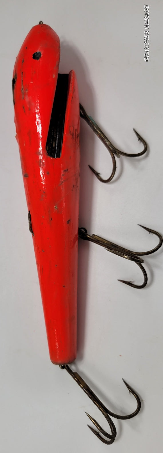 LARGE ORANGE WOODEN 10" LURE with BLACK EYES AND MOUTH AND 3 HOOKS.