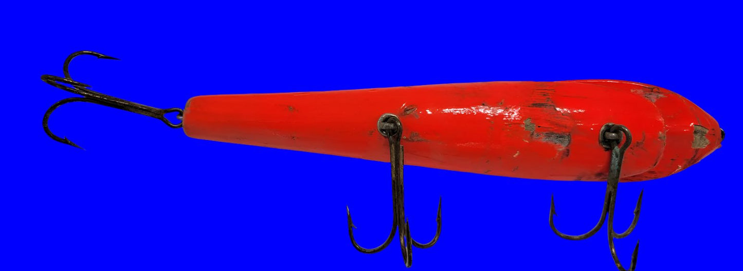 LARGE ORANGE WOODEN 10" LURE with BLACK EYES AND MOUTH AND 3 HOOKS.