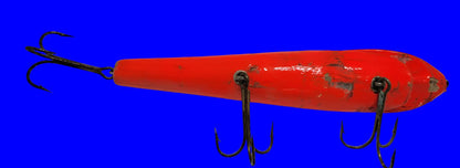 LARGE ORANGE WOODEN 10" LURE with BLACK EYES AND MOUTH AND 3 HOOKS.