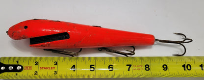 LARGE ORANGE WOODEN 10" LURE with BLACK EYES AND MOUTH AND 3 HOOKS.