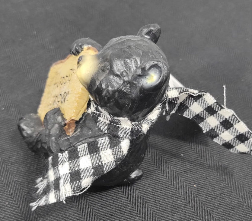 Small black with sign and checkered cape on a textured 