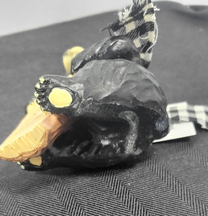 Close-up of a gray textured scarf on a black bear decorative figurine